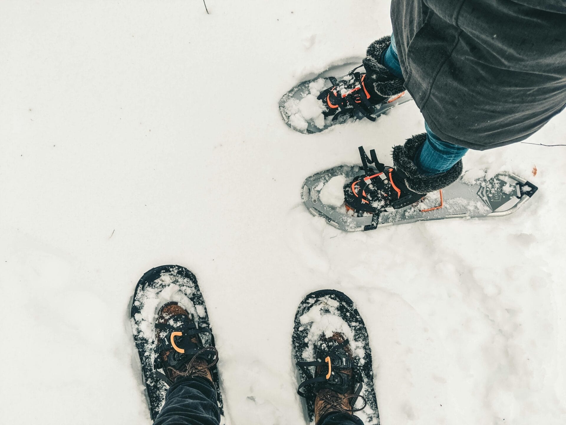 A close-up view of people engaged in snowshoeing in the snow-covered wilderness of Canada.