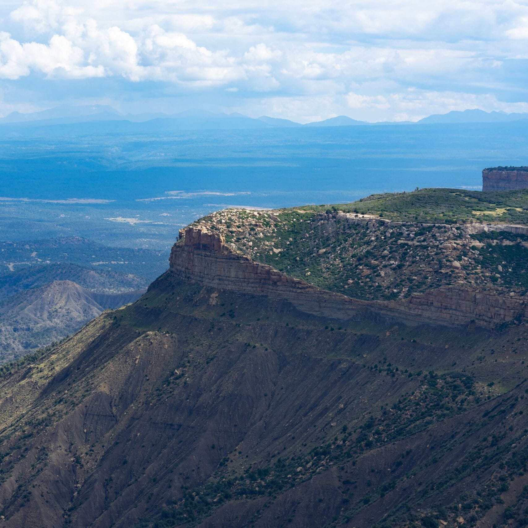 Explore the stunning aerial view of the majestic Mesa Verde cliffs in Colorado, showcasing nature's beauty.